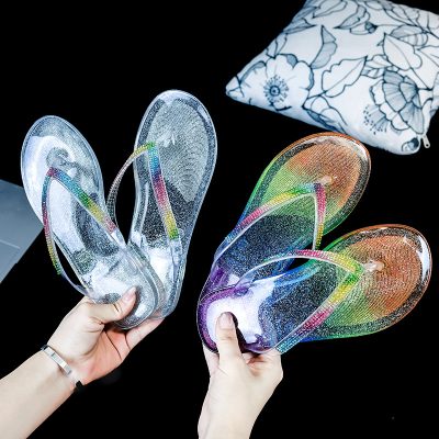 Women's jelly flip flops with colorful rhinestone edging