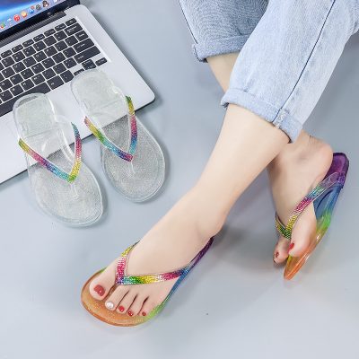 Women's jelly flip flops with colorful rhinestone edging