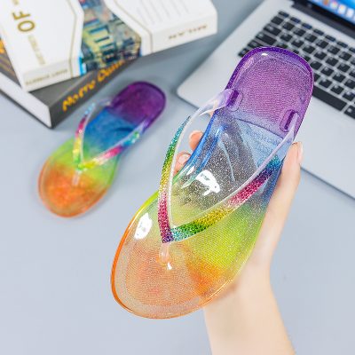 Women's jelly flip flops with colorful rhinestone edging