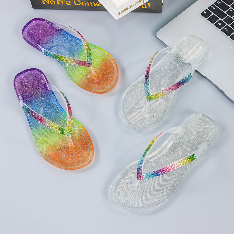 Women's jelly flip flops with colorful rhinestone edging